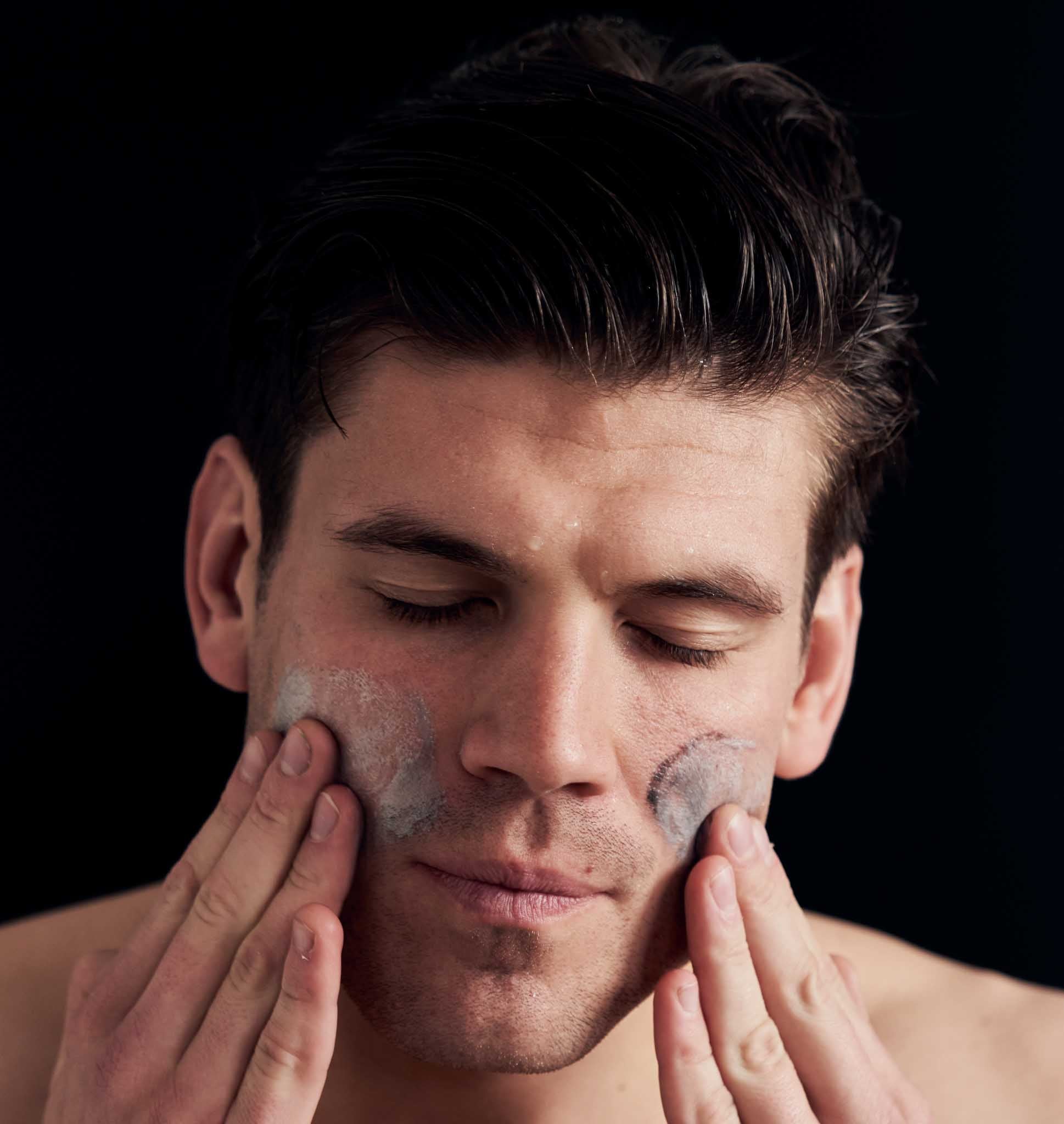 Person washing face with revate activate facial cleanser