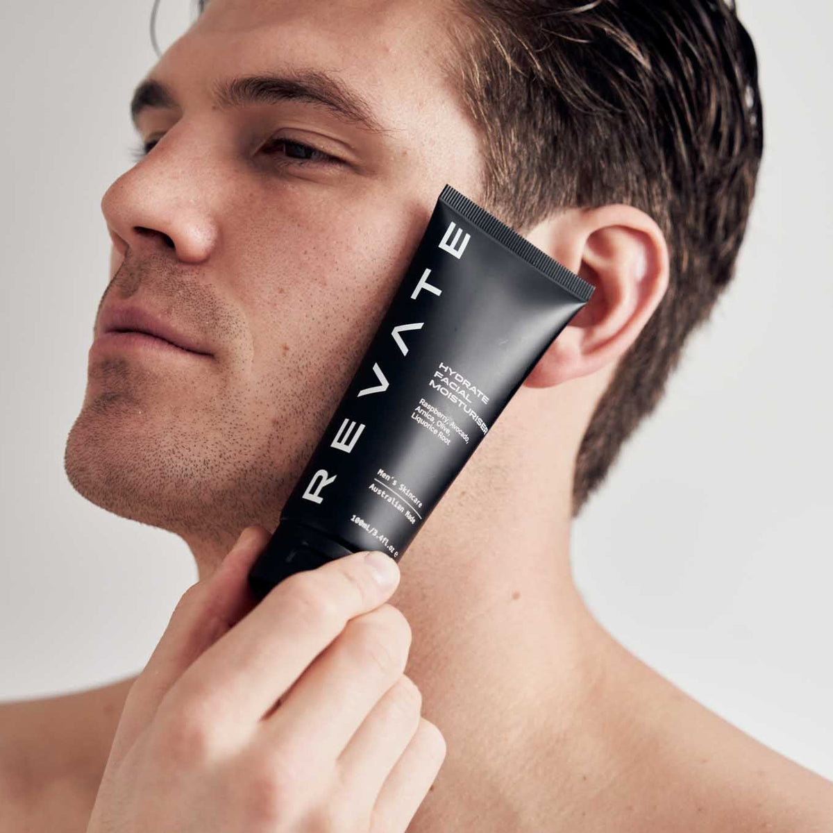 Revate hydrate facial moisturiser held next to face best